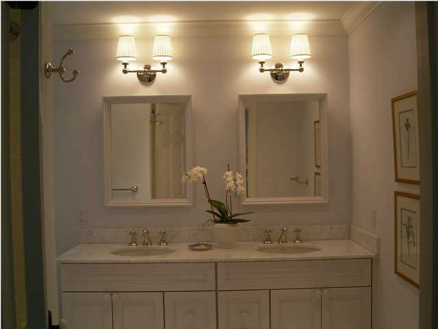 Master bath has Rohl faucets, furniture vanity with Carrara marble top and 